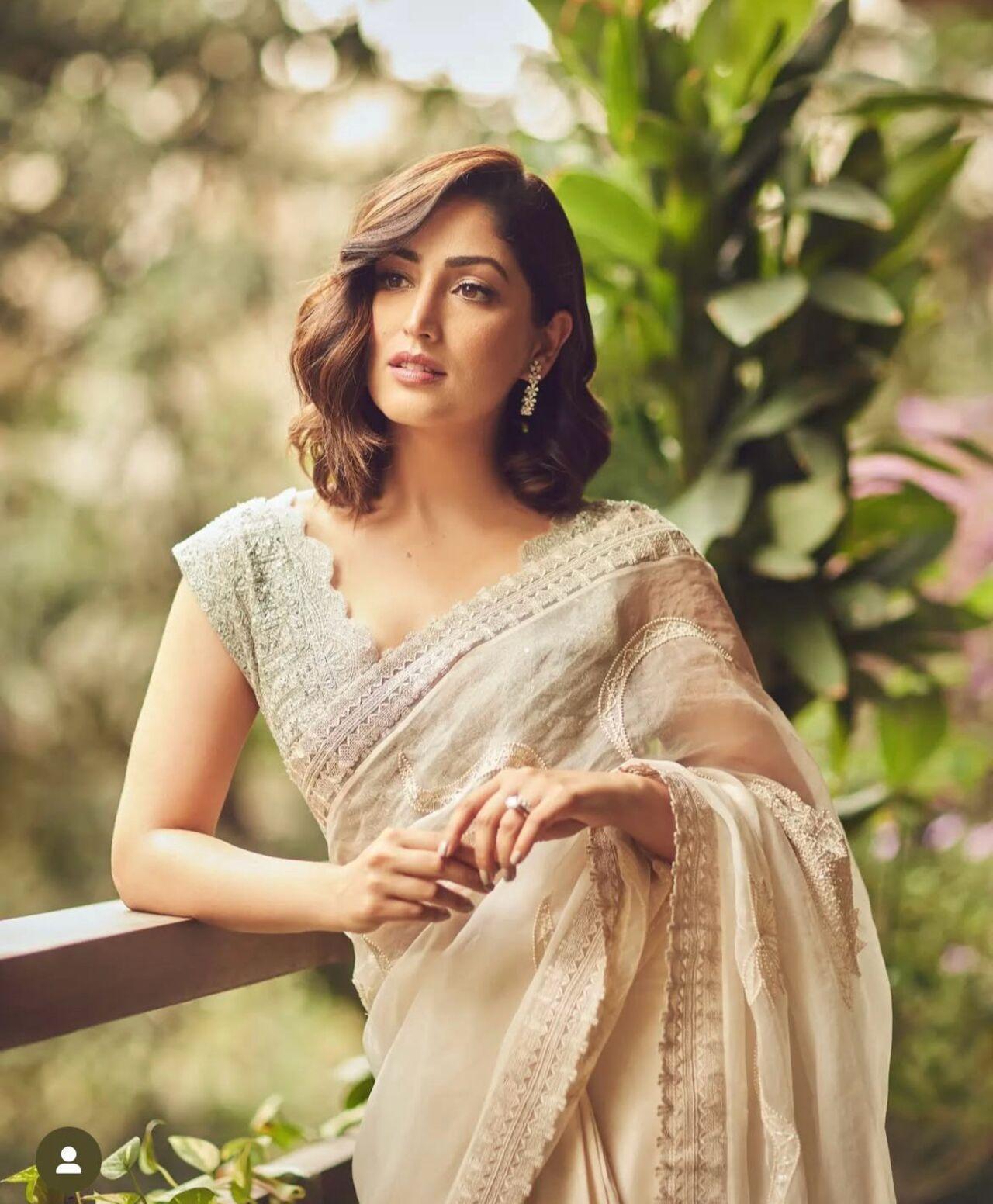 Yami Gautam's ivory sheer saree with delicate embroidery and vintage curls was grace personified. Her serene aura and minimal styling make this look ideal for an intimate family celebration.